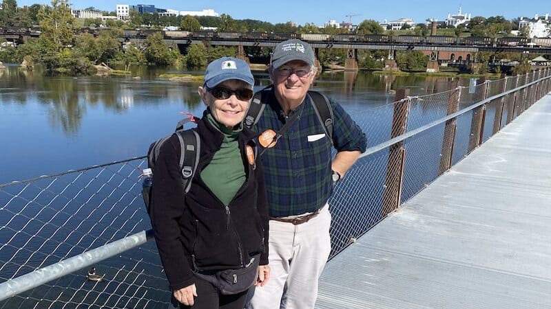 Stuart and Pamela Davis, natives of New York and Maine, and now residents of Arlington, travel to the shores of the James River in Richmond every year for the Richmond Folk Festival: “How wonderful to have something like this in the heart of the city!” They are photographed here on the T-Pott Bridge. Image