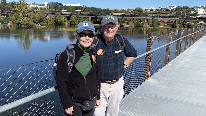 Stuart and Pamela Davis, natives of New York and Maine, and now residents of Arlington, travel to the shores of the James River in Richmond every year for the Richmond Folk Festival: “How wonderful to have something like this in the heart of the city!” They are photographed here on the T-Pott Bridge.