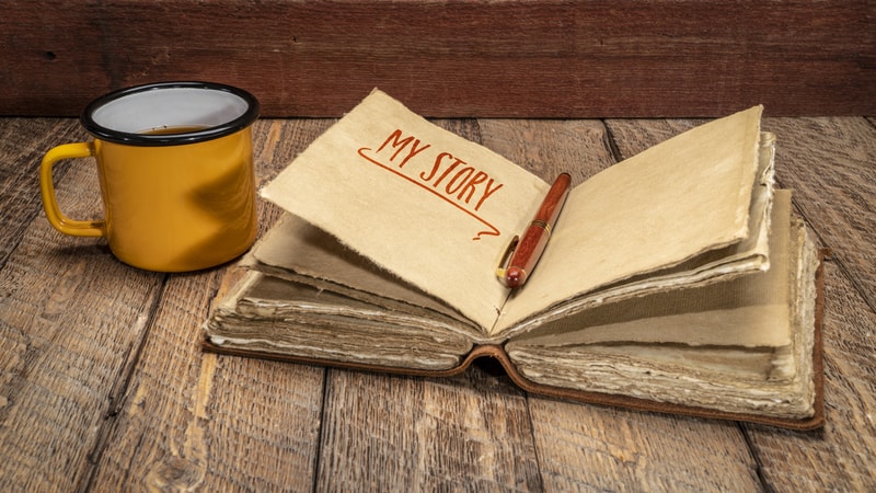 A mug and My Story journal on a wooden table, from Marek Jliasz. Author Rod Martinez writes about the book that you have in you and why you should write your personal memoir.