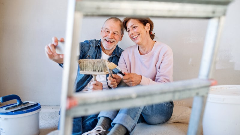 Couple taking a breather during a home DIY painting project, from Pojoslaw. Learn how to paint your home with ease, from prepping your walls to choosing the right tools and paint and calculating the amount of paint.