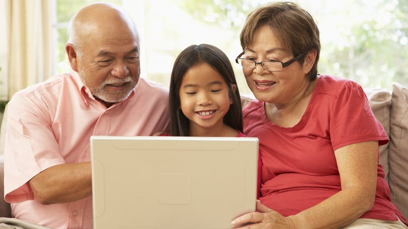 grandparents granddaughter on a laptop, from Monkey Business Images, perhaps playing a puzzle like the Jumble puzzles