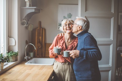 A happy senior couple at their kitchen sink in the morning. They know how to start the morning strong. Courtesy Getty Images and Buddha Teas