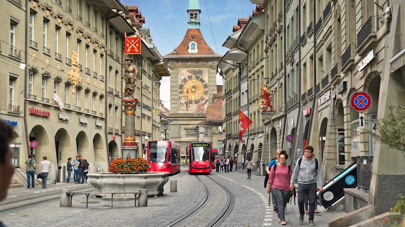 The famous clock tower in the Swiss city of Bern, part of the original wall around the city, looms at the head of Marktgasse street. CREDIT: Rick Steves