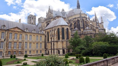 A glorious example of Gothic architecture, Reims Cathedral's construction began in 1211. Around the back of the church, flying buttresses are hard at work, supporting the massive structure.
