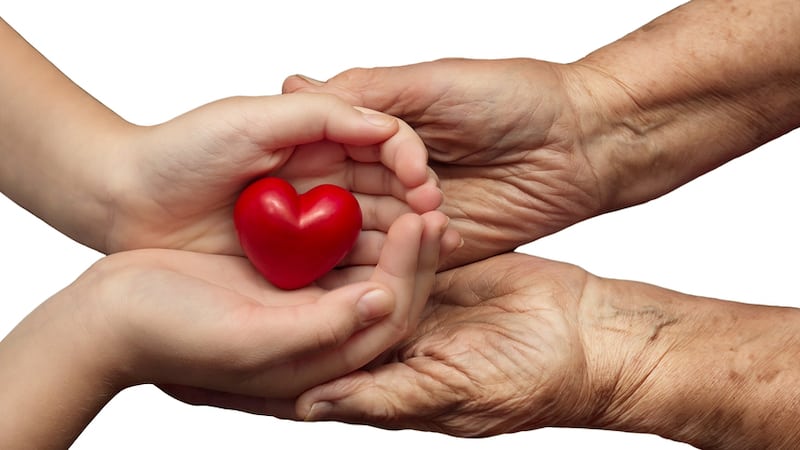 young hands and old hands exchanging a bright red heart. From Kosobu. For article, Did I Learn Anything from the Pandemic?