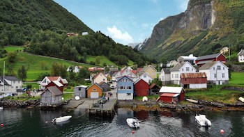 In Norway’s magnificent Sognefjord region, idyllic villages come with a mountainous backdrop. One such village, Undredal, lies along the ‘Norway in a Nutshell’ route sampling the area’s highlights. CREDIT: Rick Steves. 