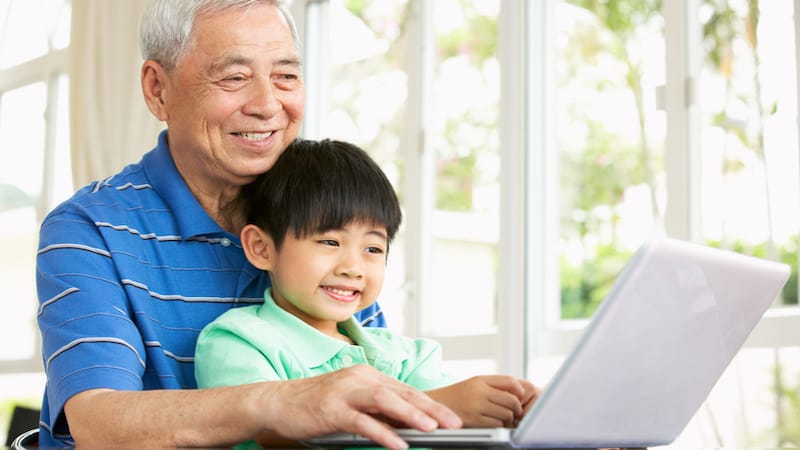 Granddad and grandson on a laptop, by Monkey Business Images. For Jumble for Kids and Adults puzzle, with "Fired" theme.