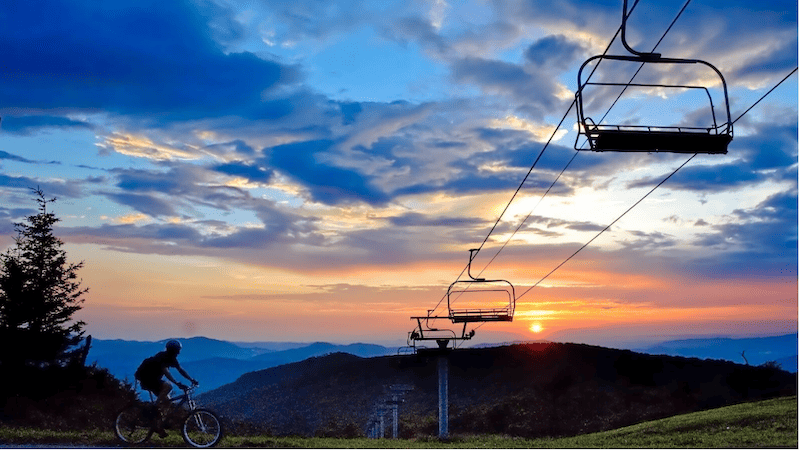 Emerald Outback sunset at Beech Mountain, with bike and ski lift chairs. Credit - Kristian Jackson.PNG
