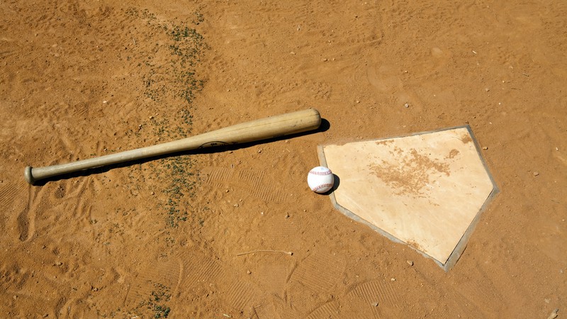 A baseball bat, baseball, and home plate, signifying the end of the season. For What's Booming, August 31 to Sept. 7