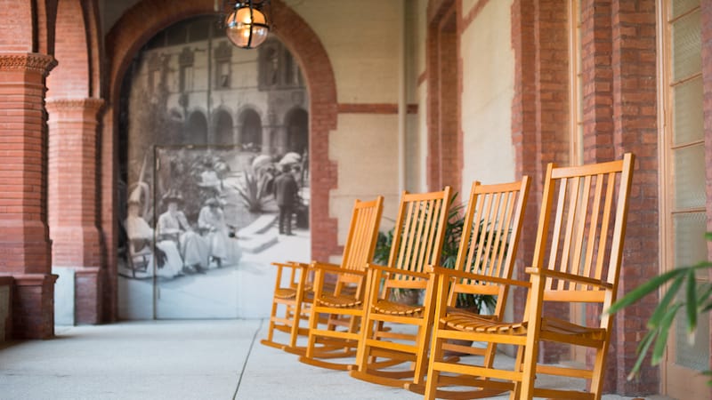an old college portico with four rocking chairs and large old photo. CREDIT Josephthomas. Boomer reader Naomi Marcus knows hesitated to go to her reunion. She recalls her challenges attending Columbia University Journalism School. She knows very valid reasons not to go to a reunion. But she went.
