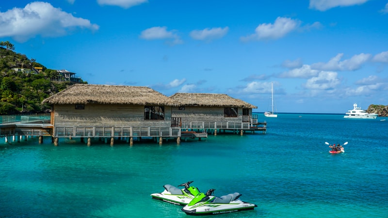 overwater bungalow at an Antigua resort, by Zhukovsky. One of the possible deals on a fall vacation.