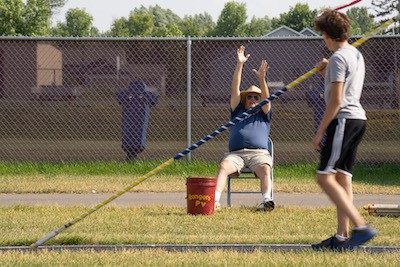 Mike Soule offered advice as David Gunderson worked on his pole vaulting technique during a practice at Forest Lake High School. Mike Soule, among the oldest pole vaulters in the state, coached young vaulters at Forest Lake High School Thursday afternoon, June 29, 2023. ] JEFF WHEELER • jeff.wheeler@startribune.com