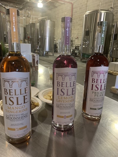 Three bottles of infusions from Belle Isle premium moonshine: Mango Tangerine, Lemon Lavender, and Prickly Pear