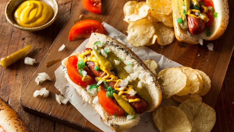 When you can’t make it to the Windy City for the renowned hot dogs, you can make them at home. Here’s the secret to DIY Chicago-style hot dogs. Image by Bhofack2