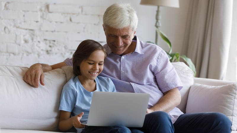 granddad and grandkid together on a laptop. Image by Fizkes. For article this week's puzzle: Jumble food fun classic and Jumble tennis tot for kids