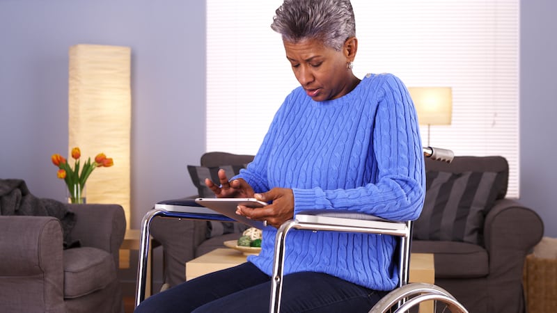 woman in wheelchair on tablet, from Mark Adams. For the Boggle puzzle country hunt.