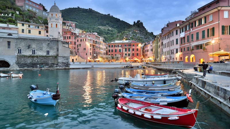 Enjoy a sunset stroll along Vernazza's breakwater at dusk when colors deepen and glow. Part of the beautiful finds in Cinque Terre.