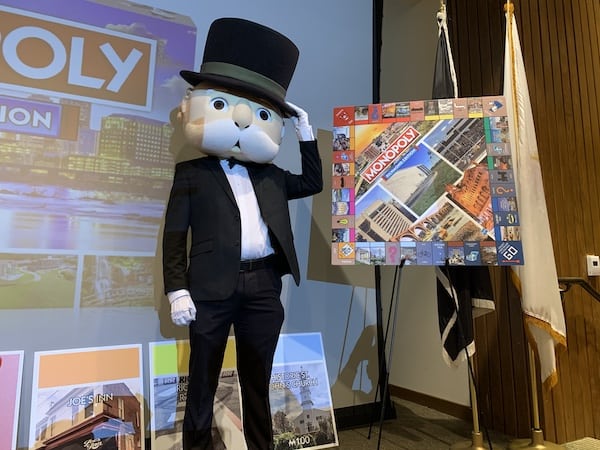 Mr. Monopoly poses beside the new MONOPOLY: Richmond Edition board.