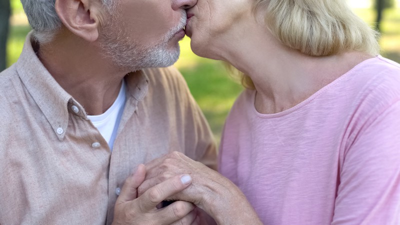 A couple kissing tenderly. By motortion. For article on a widower in love with his sister-in-law.