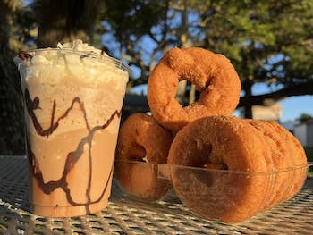Fancy coffee drink and cinnamon sugar apple cider donuts outdoor at The Dancing Turtle, Hatteras Island, NC