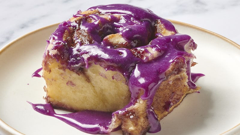 These stunning blueberry cinnamon rolls feature a soft, yeasted dough, warm brown sugar filling with a layer of blueberry sauce, and a drizzle of blueberry cream cheese glaze.