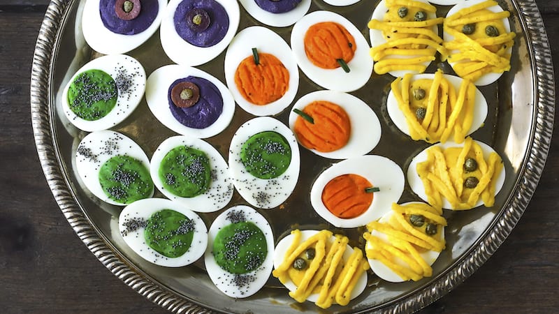 Halloween deviled eggs: a pumpkin, mummy, monster, and spider's nest.