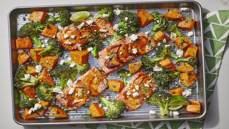 The vibrant combo of cheese, cilantro, chili and lime makes this salmon sheet-pan dinner with sweet potatoes and broccoli burst with flavor.