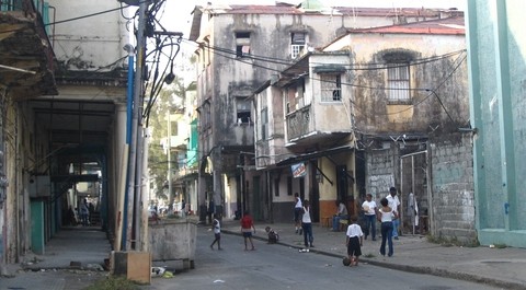 impoverished area, children playing in the streets. Image by Alexvu. For article encouraging travel outside of the guidebook.