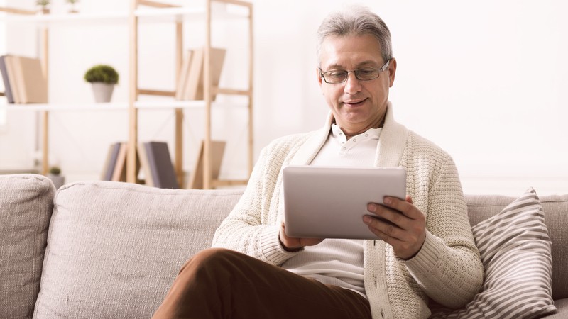 man on tablet, maybe finding the Boggle hidden countries. Prostockstudio