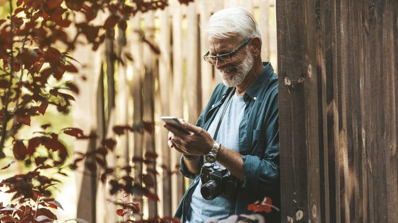 A man on phone outside, for article on a clueless silver widower. Image by Andrei Zastrozhnov