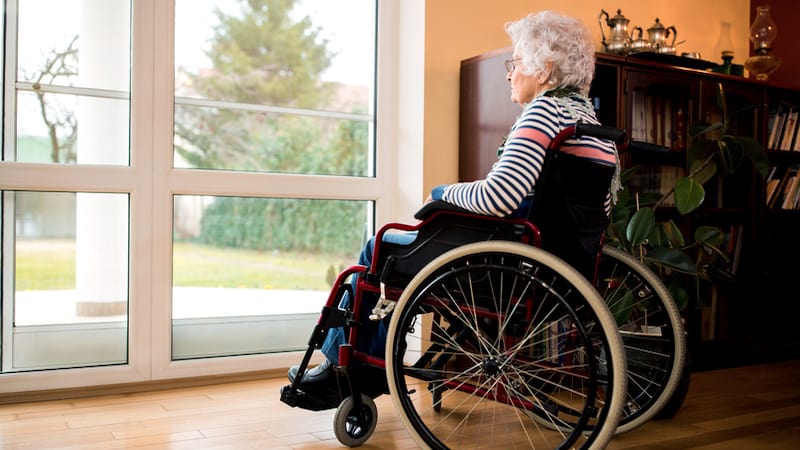 A sad woman in a wheelchair in a nursing home, by Didesign021. For article on "Whatever happened to living like the Waltons," when the elders shared the family home?