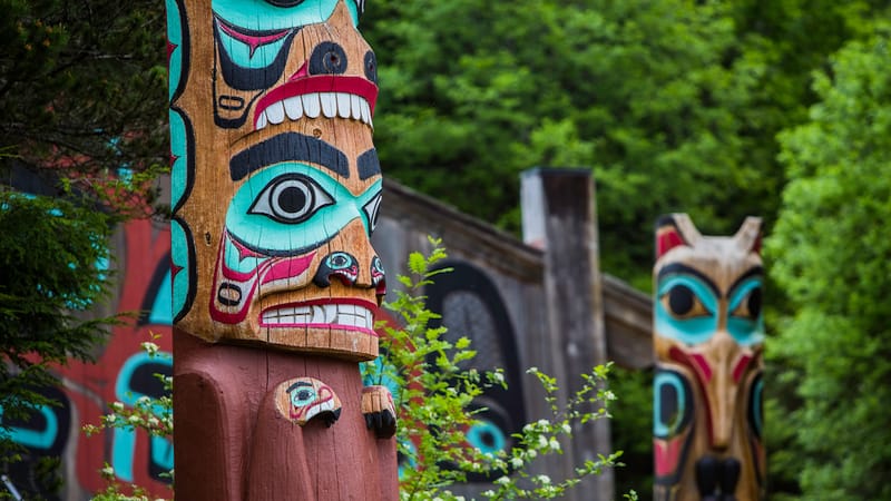 Totem poles in Saxman Native Village. Image by Anna Griessel, article on traveling outside of the guidebook