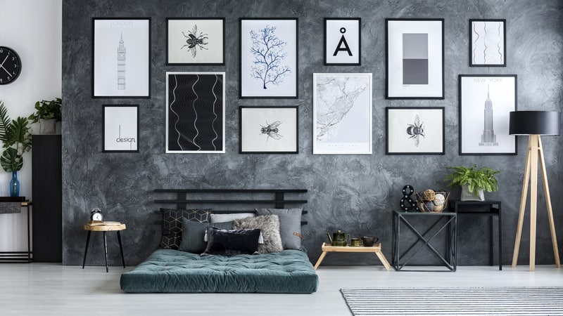 A modern room with an arrangement of posters on the wall. By Katarzyna Bialasiewicz.