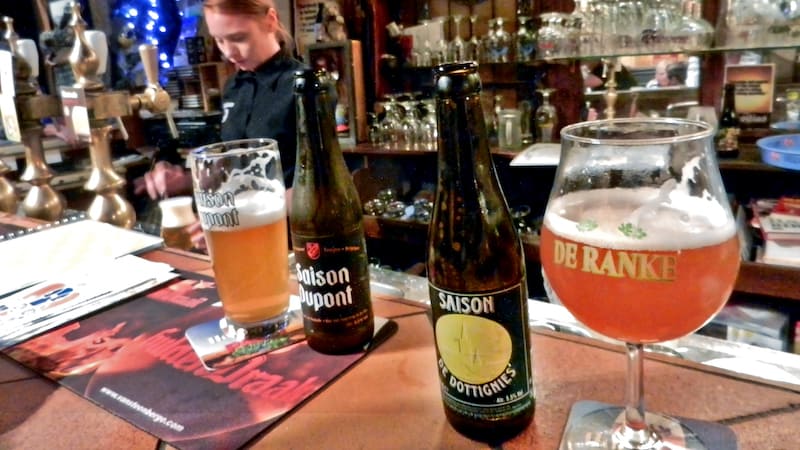 Belgian beer bottles and beer in glasses at 't Brugs Beertje in Bruges, Belgium