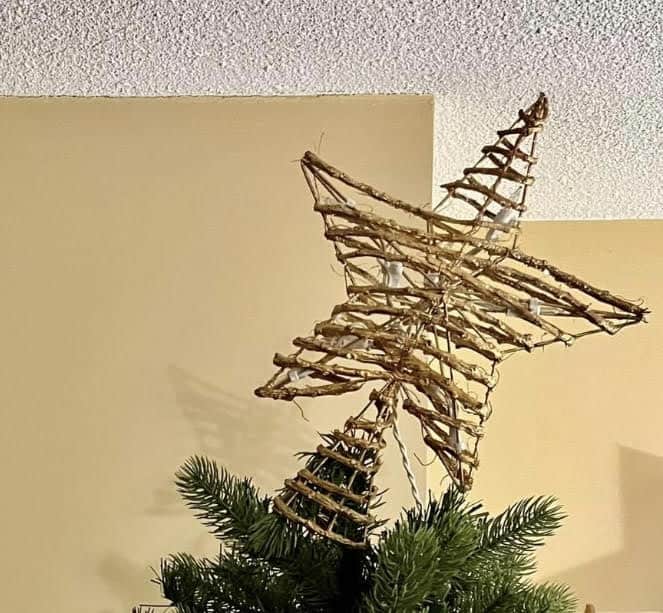 a tilted star atop a Christmas tree, for article looking back on 2023.