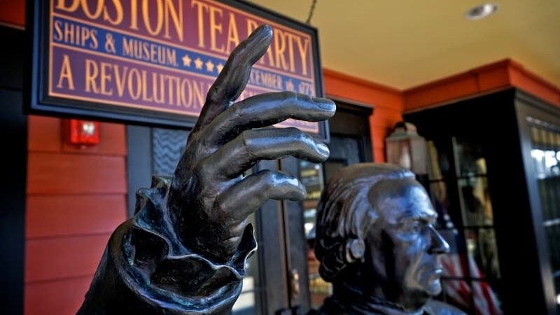 boston tea party museum with statue of patriot in front. Credit Pivariz. Drink in the season and patriotic fervor!