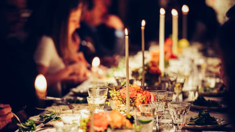 candlelight dinner party, by Mykyta Starychenko. Article on exhausted holiday hostess