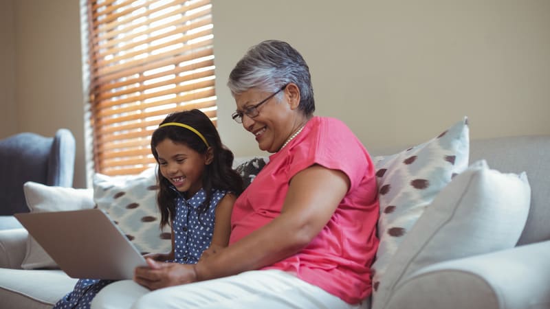 grandmother and granddaughter on a laptop. For Jumble Puzzles with Baffled Males