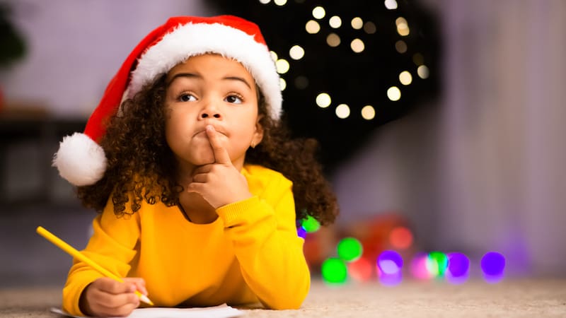 little girl making christmas list. credit Prostockstudio