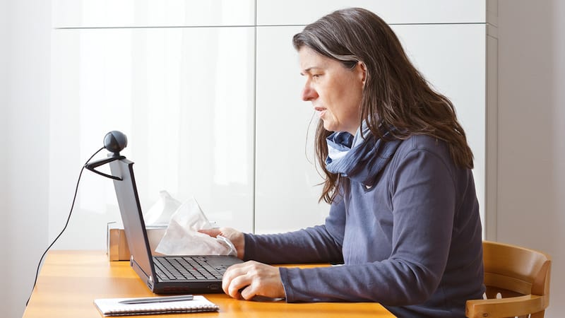 woman on computer for a virtual health visit, image by Agenturfotografin. Article on Amazon One Medical Health Care