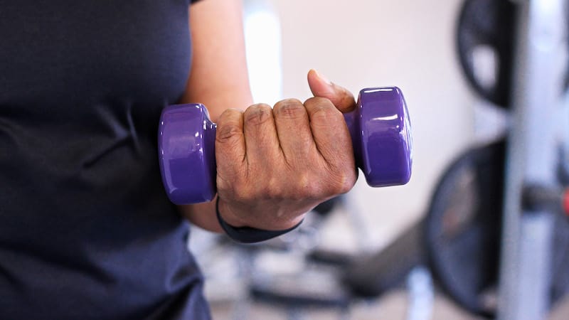 A hand holding a small weight for lifting. cardio, weights, and the right food are key to staying healthy over 50. 150 minutes of exercise throughout the week, including a balance of cardio and weightlifting, have great benefits for people over 50. (Dreamstime/TNS)