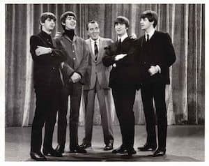 The Beatles with TV show host Ed Sullivan - 73 million Americans watched, including Baby Boomers in the formative years of their lives, ever linking The Beatles and Boomers.