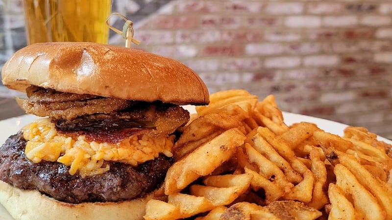 Pimento cheese burger and beer and waffle fries at Crafted Restaurant in Richmond, Virginia. Image credit Crafted, created for "100 Things to Do in Richmond Before You Die" by Annie Tobey and used in article on Richmond bucket list restaurants.