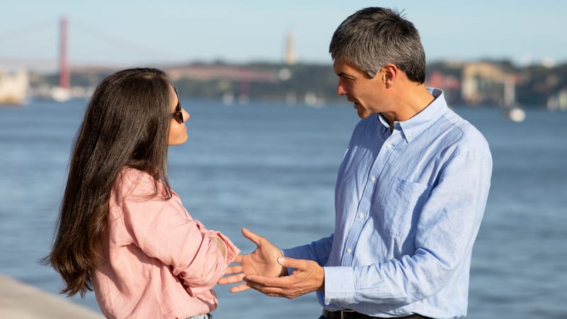 A couple outside arguing. By Prostockstudio. Article on "Is a hurtful joke OK?"