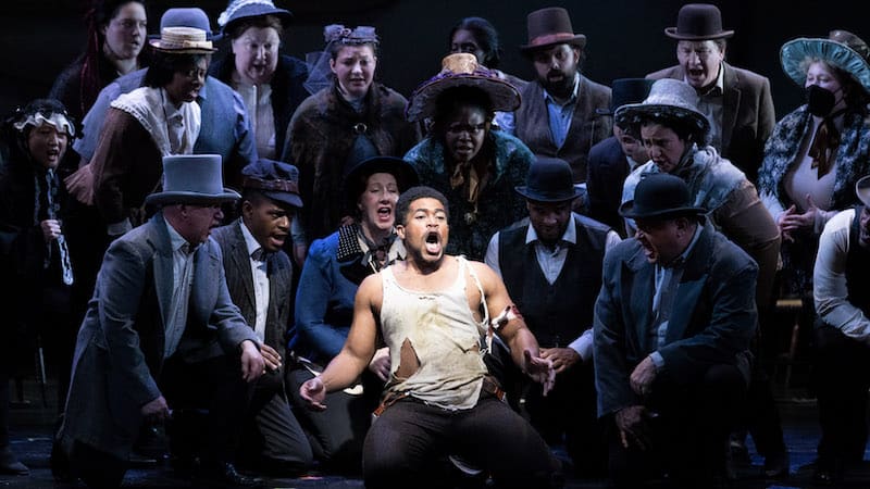 Terrence Chin-Loy (center) as Welsey Harris escaping enslavement while running surrounded by the Virginia Opera Chorus. Image by Dave Pearson.