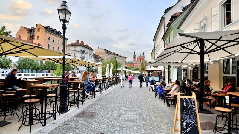 Slovenia: Ljubljana’s riverfront promenade is lined with quaint boutiques, great restaurants, and cafés ripe for people-watching. CREDIT: Rick Steves.