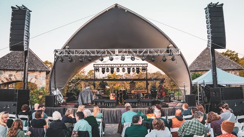 Performance shell and lights, audience, and performers. 2023 Groovin' in the Garden at Lewis Ginter.