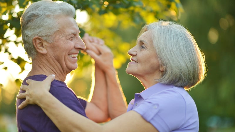 a happy dancing couple outside, image by Ruslan Huzau. Article on Dance Lessons in Life