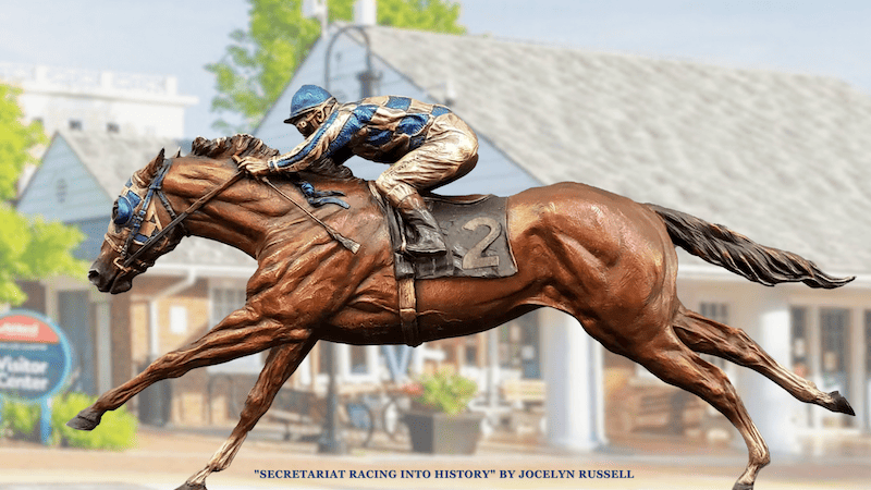 The bronze statue “Secretariat Racing Into History” by sculptor Jocelyn Russell. At 21 feet long and 11.5 feet tall, the monument depicts a larger-than-life Secretariat at a full run, ridden by jockey Ron Turcotte.