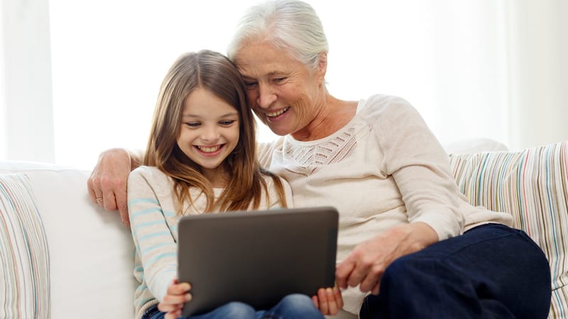grandmom and girl on tablet Syda Productions